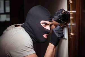Burglar wearing balaclava mask at crime scene